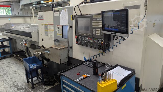 CNC lathe with bar feeder OKUMA L300-MW