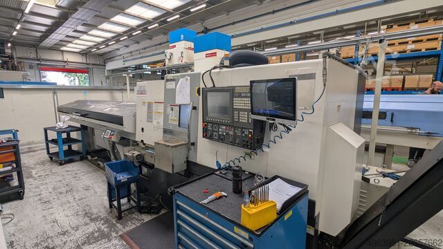 CNC lathe with bar feeder OKUMA L300-MW