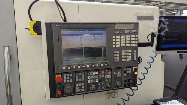 CNC lathe with bar feeder OKUMA L300-MW
