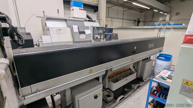 CNC lathe with bar feeder OKUMA L300-MW