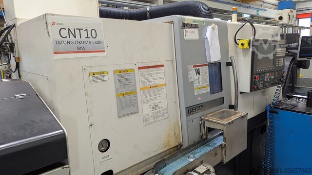 CNC lathe with bar feeder OKUMA L300-MW
