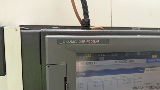 CNC lathe with bar feeder OKUMA L300-MW