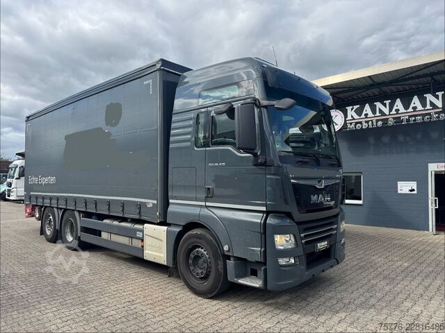 Flatbed truck with tarp MAN 26.470 XXL TGX  Mitnahmestapler Moffett M4 NX