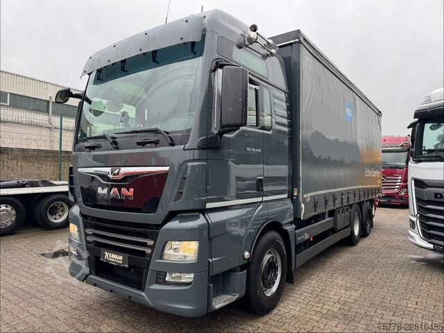 Flatbed truck with tarp MAN 26.470 XXL TGX  Mitnahmestapler Moffett M4 NX