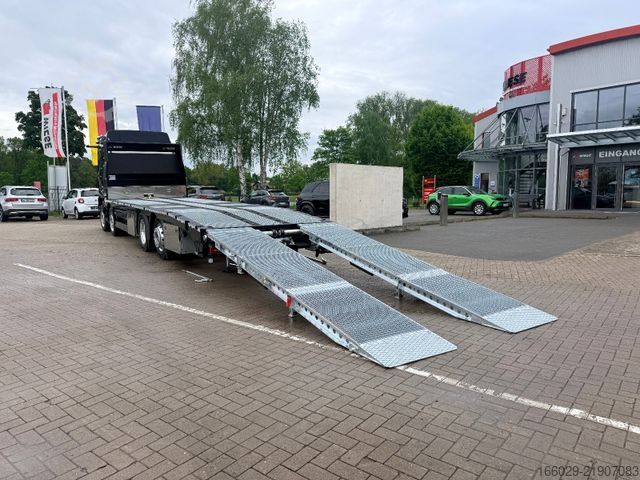 Flatbed truck MAN Baumaschinen Maschinentransporter mit Rampen