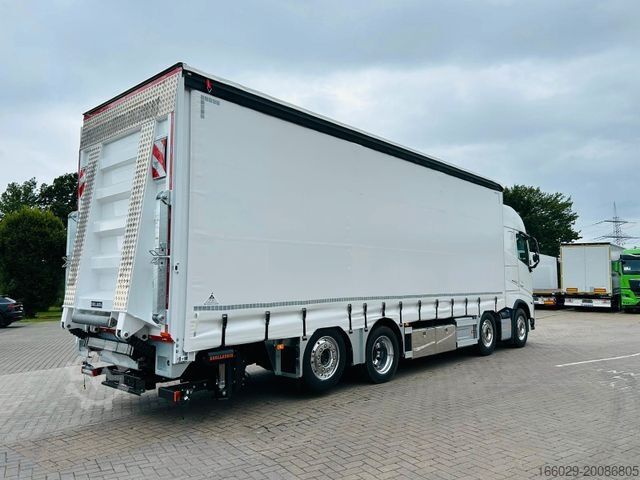 Flatbed truck with tarp VOLVO FH 500 Gabelstaplertransporter LBW Dhollandia 9t
